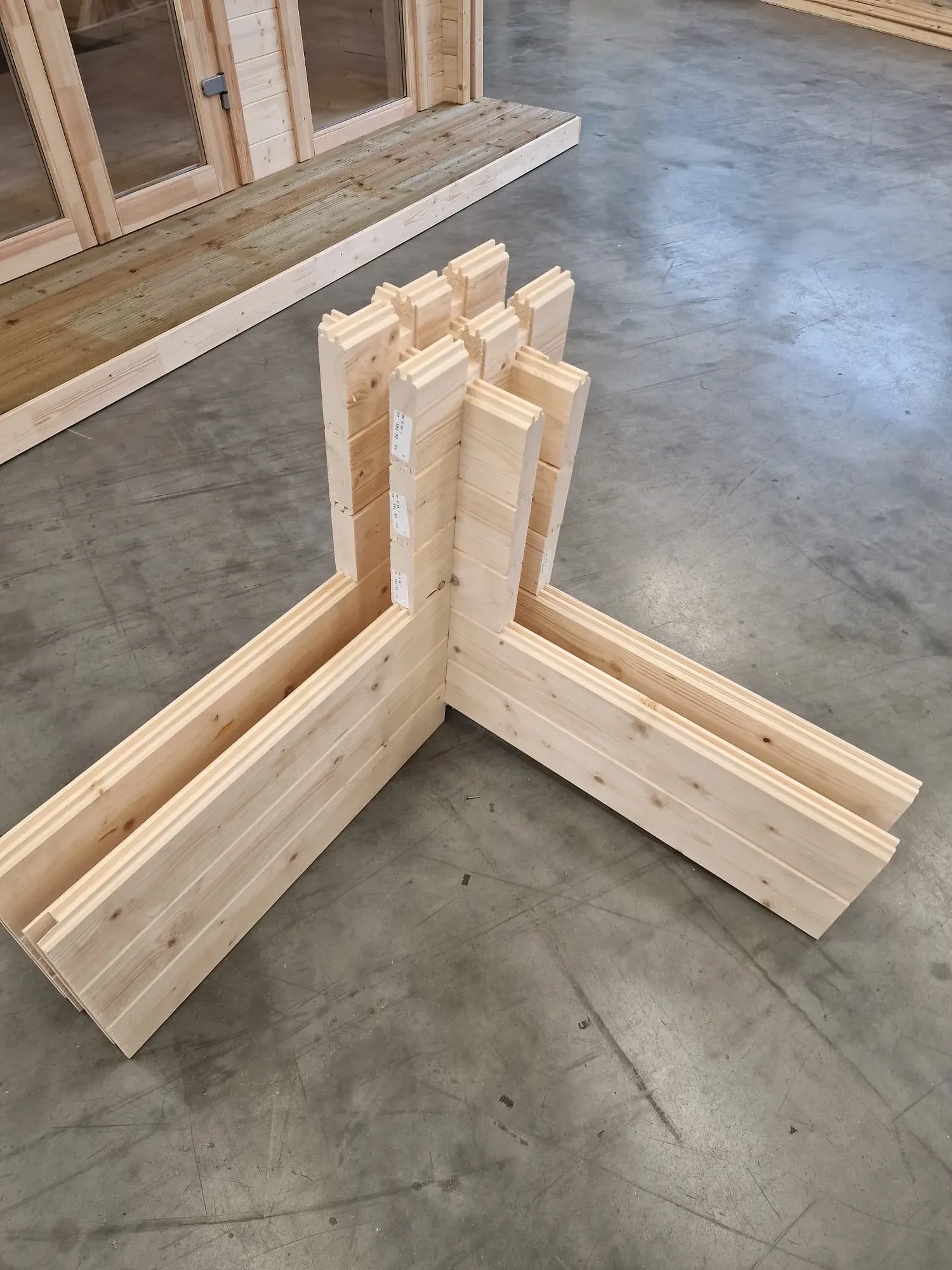 Interlocking corner joint of machined spruce logs in our factory.